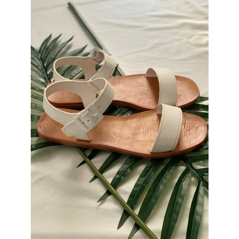 white one band flip flop sandal that straps at the ankle