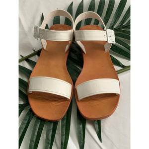 white one band flip flop sandal that straps at the ankle